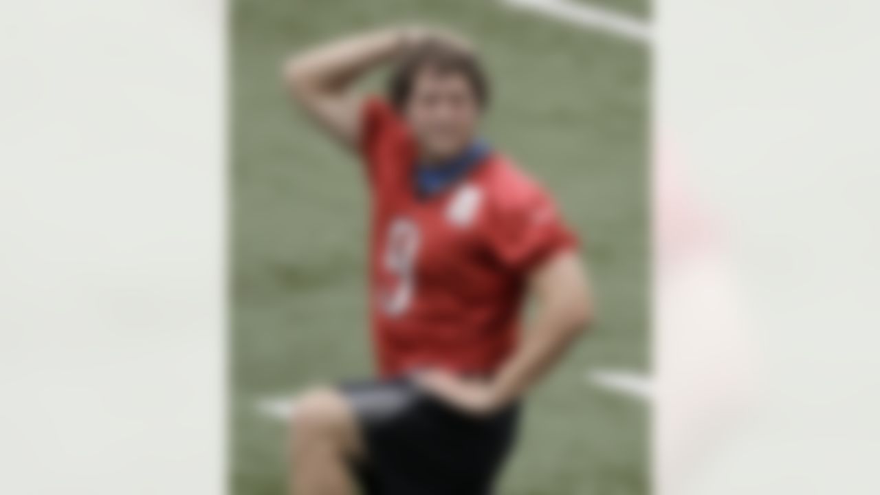 Detroit Lions quarterback Matthew Stafford stretches during NFL football training camp at the team's indoor practice facility in Allen Park, Mich., Friday, July 29, 2011. (AP Photo/Paul Sancya)