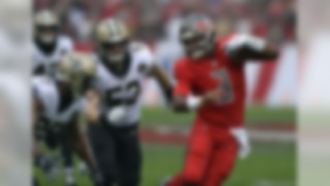 Tampa Bay Buccaneers quarterback Jameis Winston (3) tries to elude New Orleans Saints cornerback Eli Apple (25) and outside linebacker A.J. Klein (53) on a run during the first half of an NFL football game Sunday, Dec. 9, 2018, in Tampa, Fla. (AP Photo/Jason Behnken)