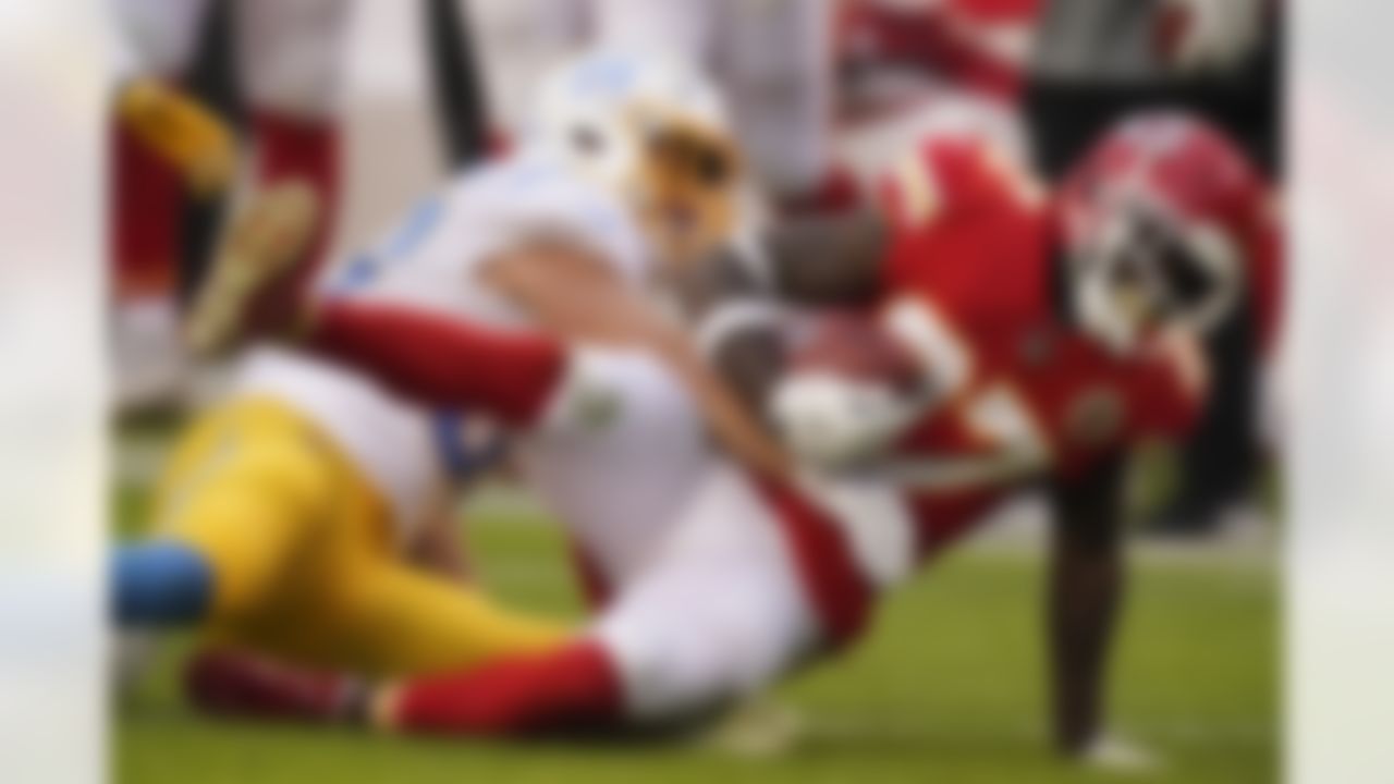 Kansas City Chiefs' Rashad Fenton is tackled by Los Angeles Chargers linebacker Cole Christiansen, left, during the first half of an NFL football game, Sunday, Jan. 3, 2021, in Kansas City.