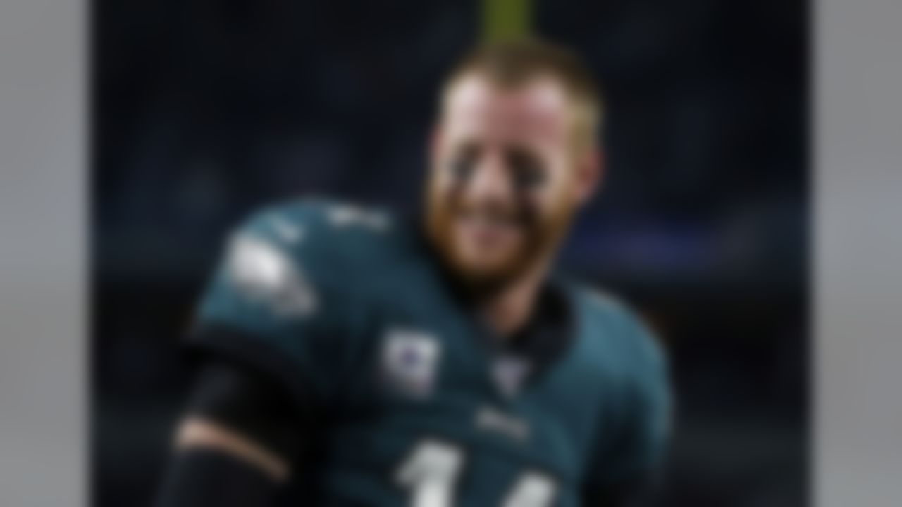 Philadelphia Eagles quarterback Carson Wentz (11) smiles as he talks with teammates during warmups before an NFL football game against the Dallas Cowboys in Arlington, Texas, Oct. 20, 2019. (AP Photo/Michael Ainsworth)