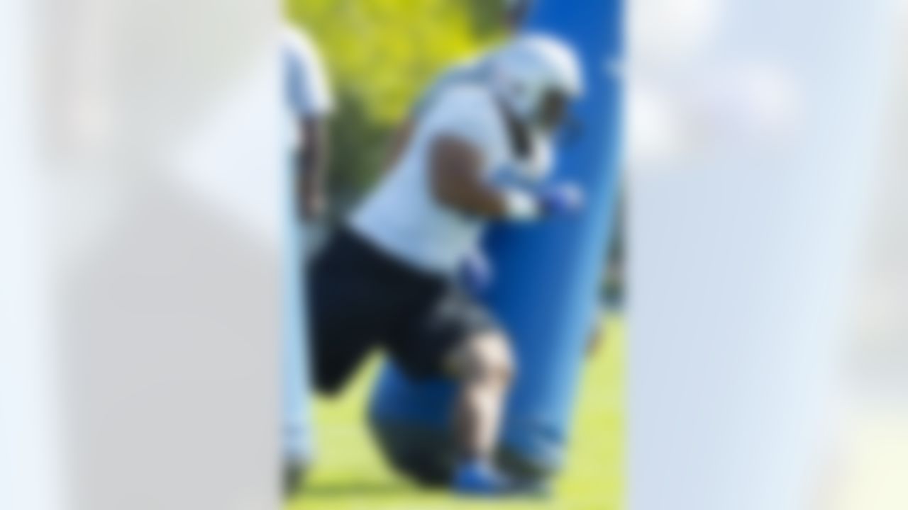 Detroit Lions defensive tackle Ndamukong Suh (90) runs drills during NFL football training camp at the team's practice facility in Allen Park, Mich., Saturday, July 30, 2011. (AP Photo/Rick Osentoski)