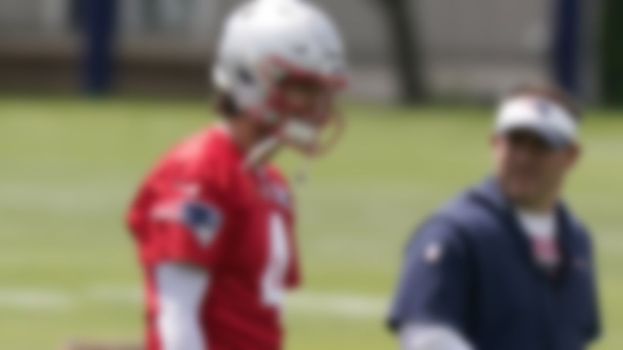 New England Patriots quarterback Jarrett Stidham (4) speaks with offensive coordinator Josh McDaniels, right, during an NFL football practice, in Foxborough, Mass., Thursday, June 10, 2021.