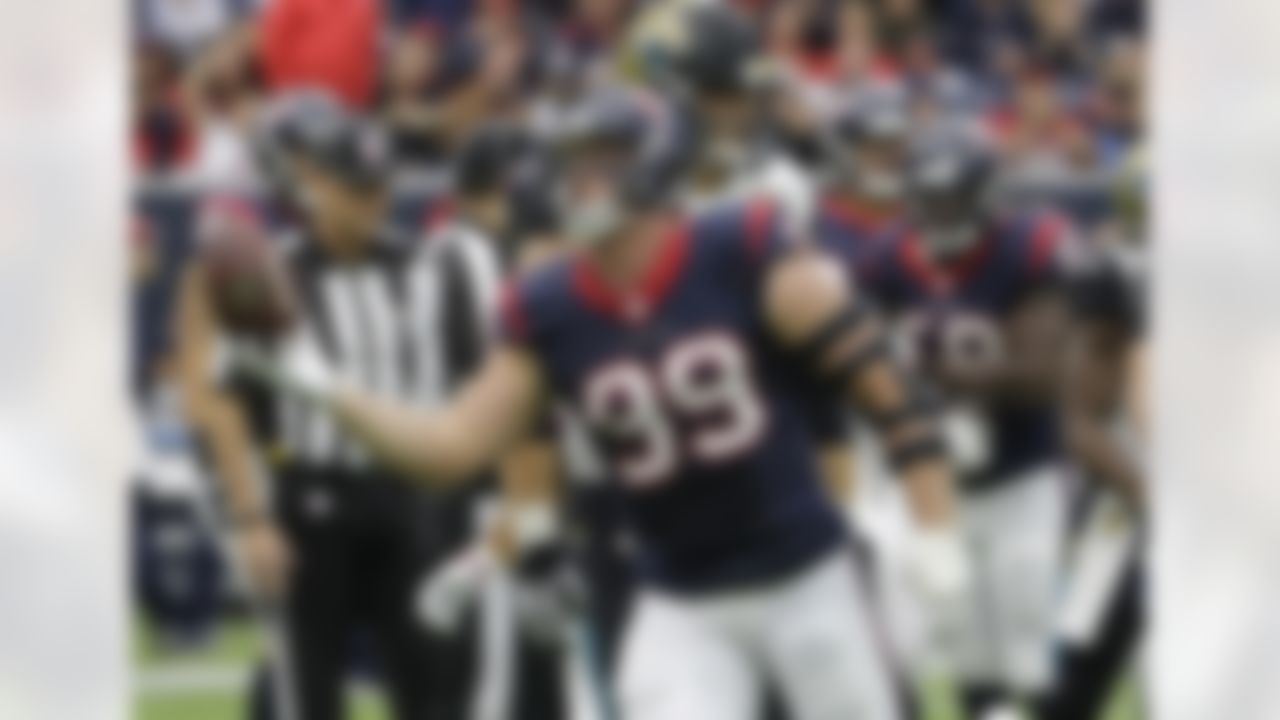 Houston Texans defensive end J.J. Watt (99) hold the football after recovering a Jacksonville Jaguars fumble during the first half an NFL football game Sunday, Jan. 3, 2016, in Houston. (AP Photo/David J. Phillip)
