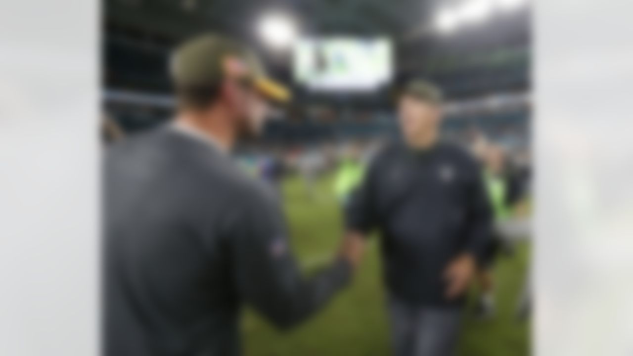 Miami Dolphins head coach Adam Gase, left, greets Oakland Raiders head coach Jack Del Rio at the end of an NFL football game, Sunday, Nov. 5, 2017, in Miami Gardens, Fla. (AP Photo/Wilfredo Lee)
