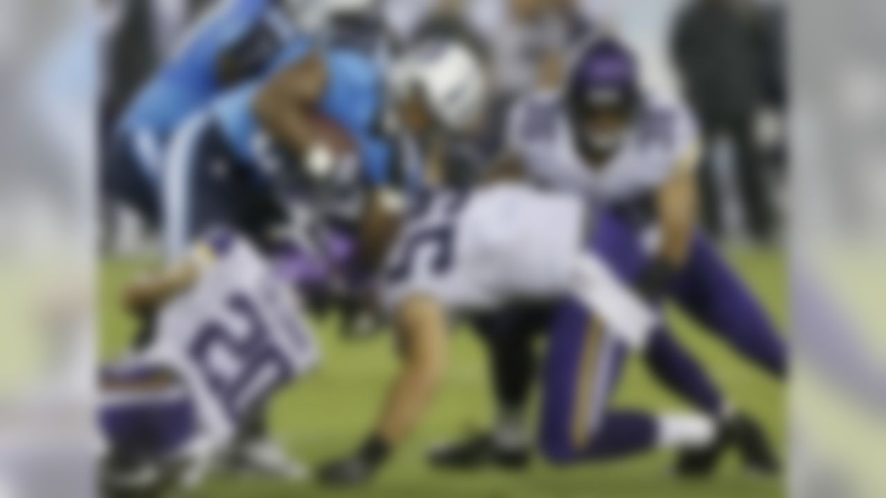 Tennessee Titans running back Bishop Sankey (20) is stopped by Minnesota Vikings defenders Kurt Coleman (20), Mike Zimmer (59) and Robert Blanton (36) in the first quarter of a preseason NFL football game Thursday, Aug. 28, 2014, in Nashville, Tenn. (AP Photo/Wade Payne)