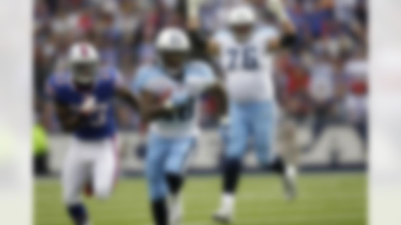 Tennessee Titans' Chris Johnson (28) runs for a touchdown under pressure from Buffalo Bills' Aaron Williams (23) during the first quarter of an NFL football game in Orchard Park, N.Y., Sunday, Dec. 4, 2011. (AP Photo/David Duprey)
