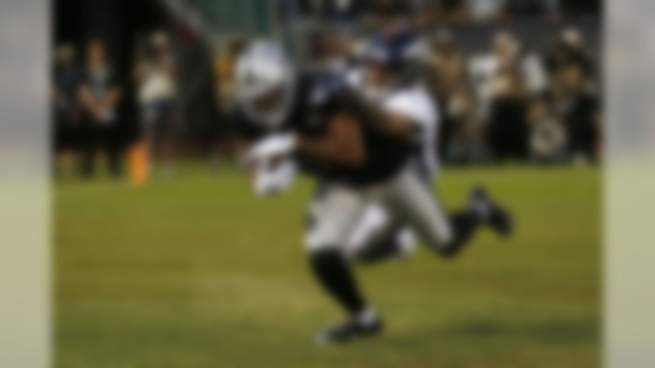 Oakland Raiders wide receiver Tyrell Williams scores a touchdown as Denver Broncos free safety Justin Simmons looks on during the first half of an NFL football game Monday, Sept. 9, 2019, in Oakland, Calif. (AP Photo/D. Ross Cameron)