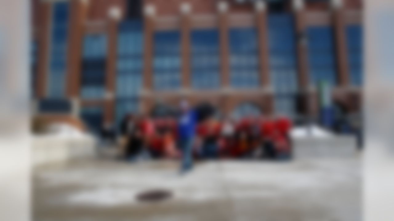 An Indianapolis Colts fan gets into a group photo of Kansas City Chiefs fans in front of Lucas Oil Stadium. (Aaron M. Sprecher/NFL)