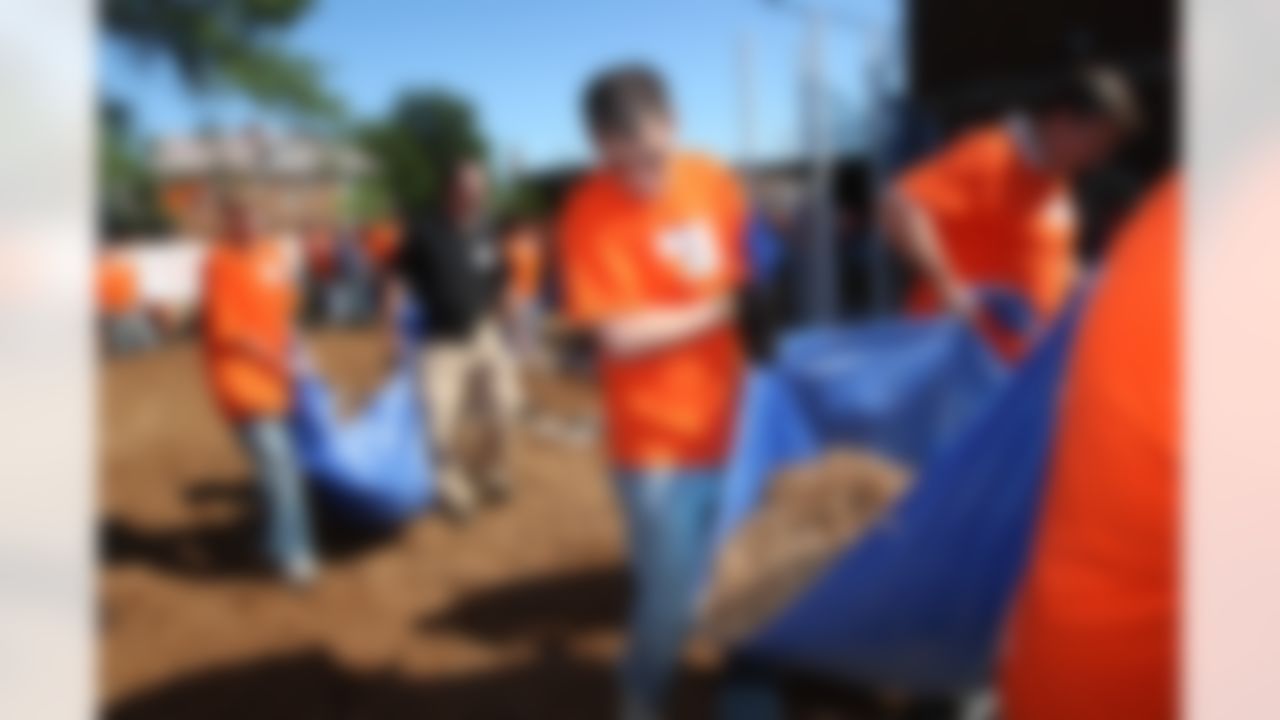 The Home Depot associates move some of the 145 cubic yards of mulch. (Photo by Tom Copeland/Home Depot)