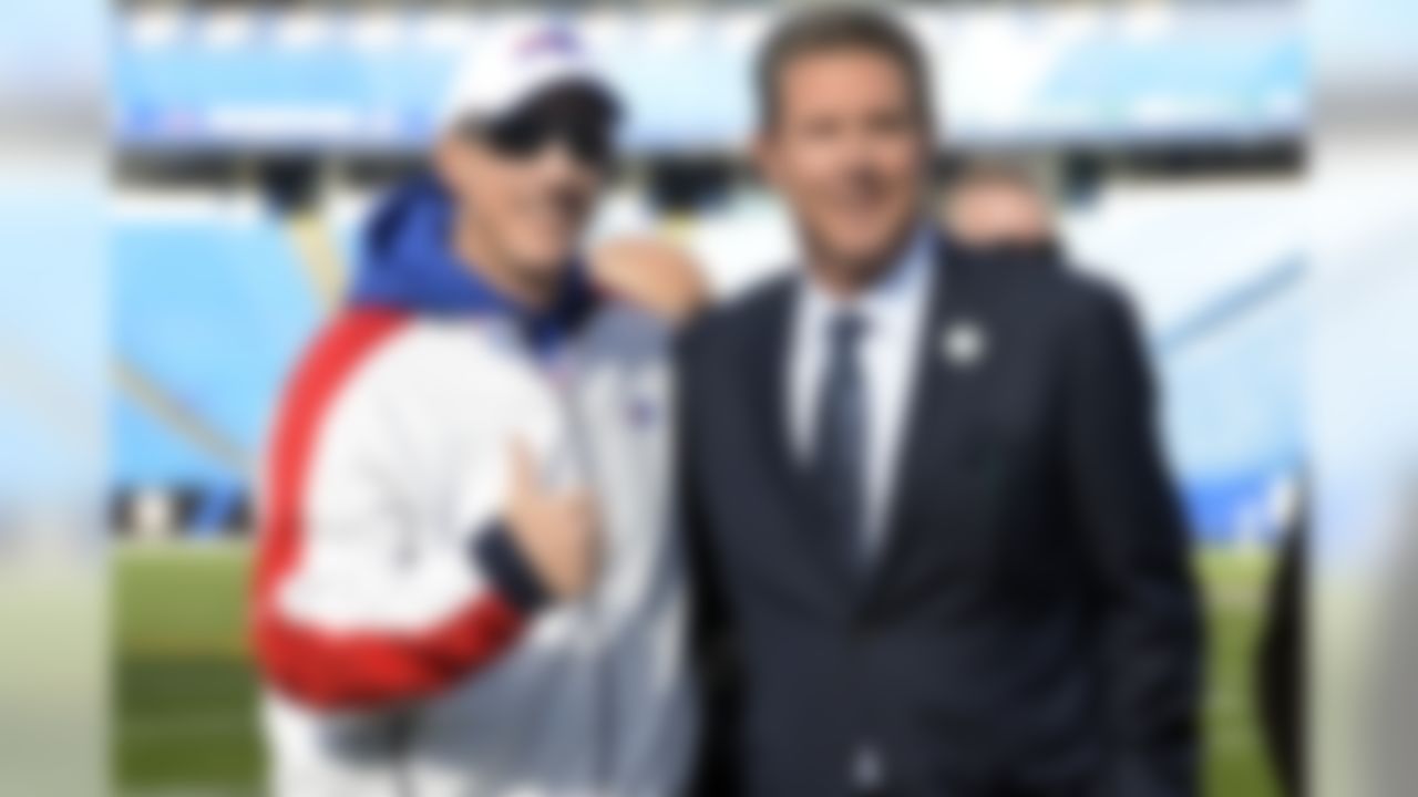 Former quarterbacks Jim Kelly, left, and Dan Marino pose for photographs before an NFL football game between the Buffalo Bills and the Miami Dolphins, Sunday, Nov. 8, 2015, in Orchard Park, N.Y. (AP Photo/Gary Wiepert)