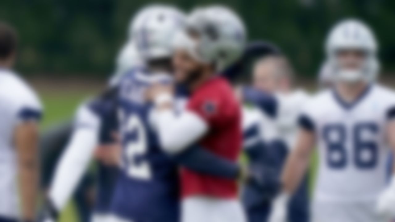 Dallas Cowboys quarterback Dak Prescott (4) hugs teammate safety Jayron Kearse (32) after Kearse intercepted a pass during an NFL football team practice Wednesday, June 9, 2021, in Frisco, Texas.