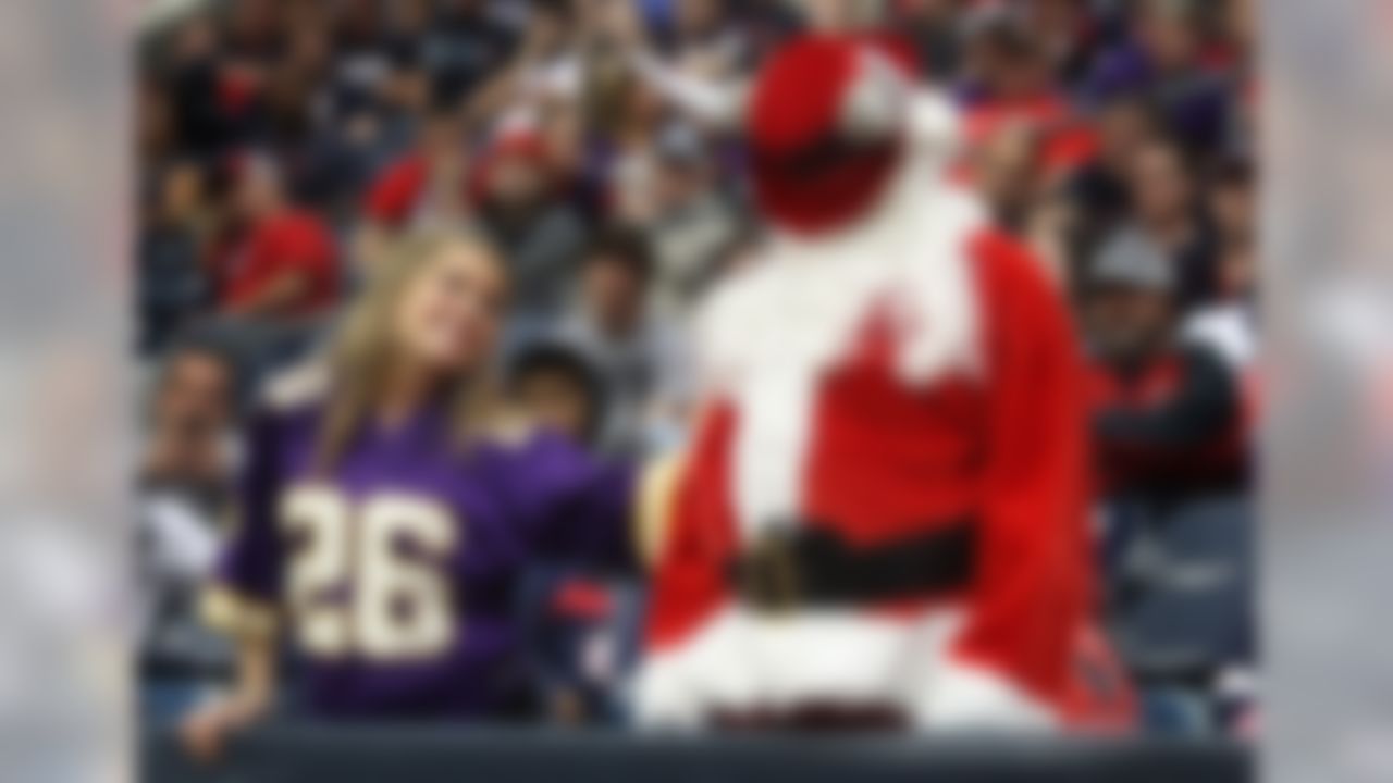 A Minnesota Vikings fan consoles Santa Claus (or, a Houston Texans fan dressed as Santa) during the Vikings' 23-6 win in Houston. (AP Photo/Patric Schneider)