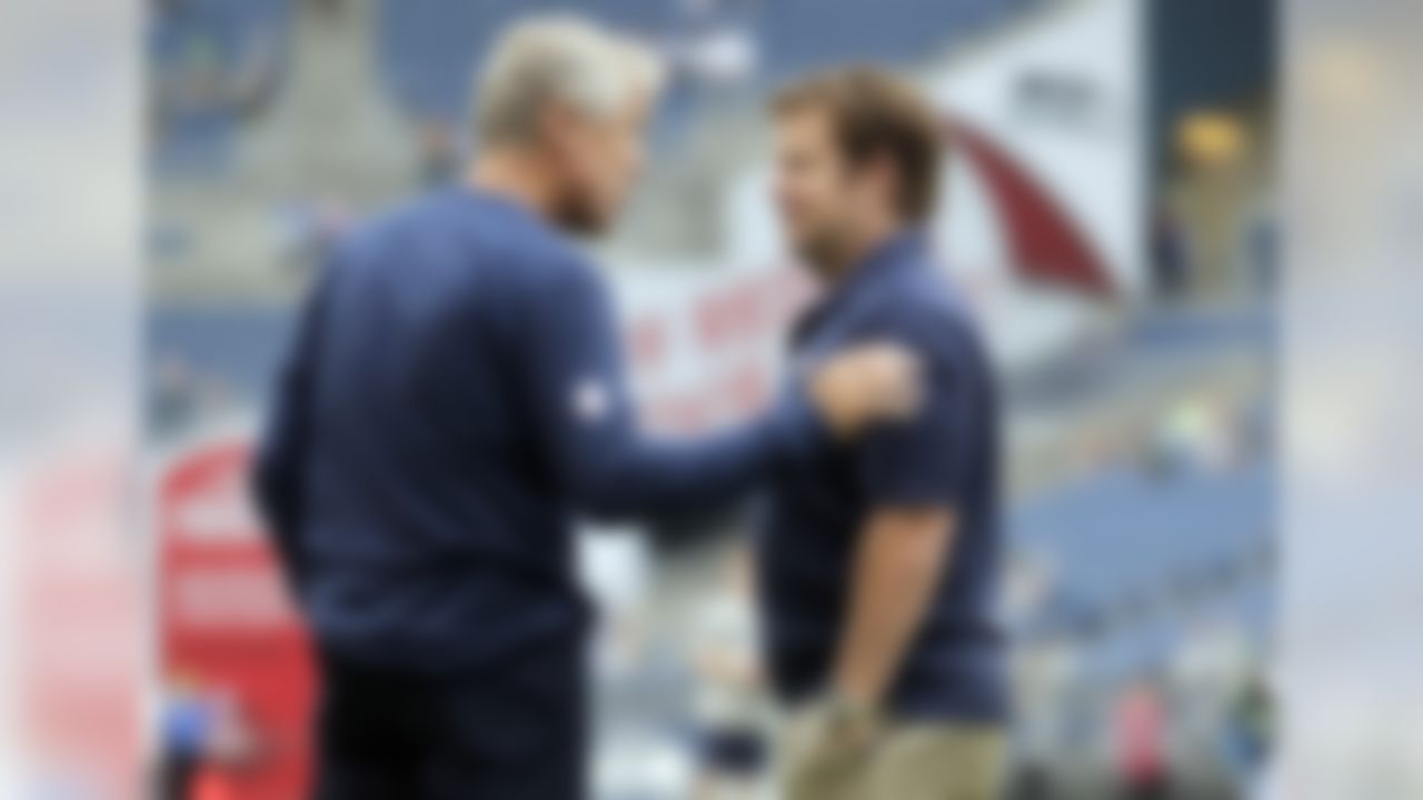 Seattle Seahawks head coach Pete Carroll, left, and Seahawks general manager John Schneider, right, talk on the field before a preseason NFL football game against the San Diego Chargers, Friday, Aug. 15, 2014, in Seattle. (AP Photo/John Froschauer)