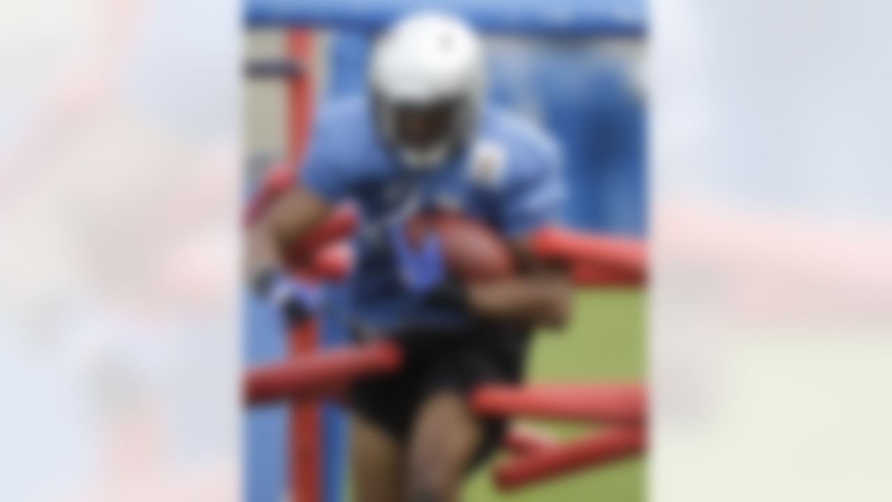 Detroit Lions running back Aaron Brown keeps the ball close during drills at the NFL football team's training camp in Allen Park, Mich., Thursday, Aug. 4, 2011. (AP Photo/Carlos Osorio)