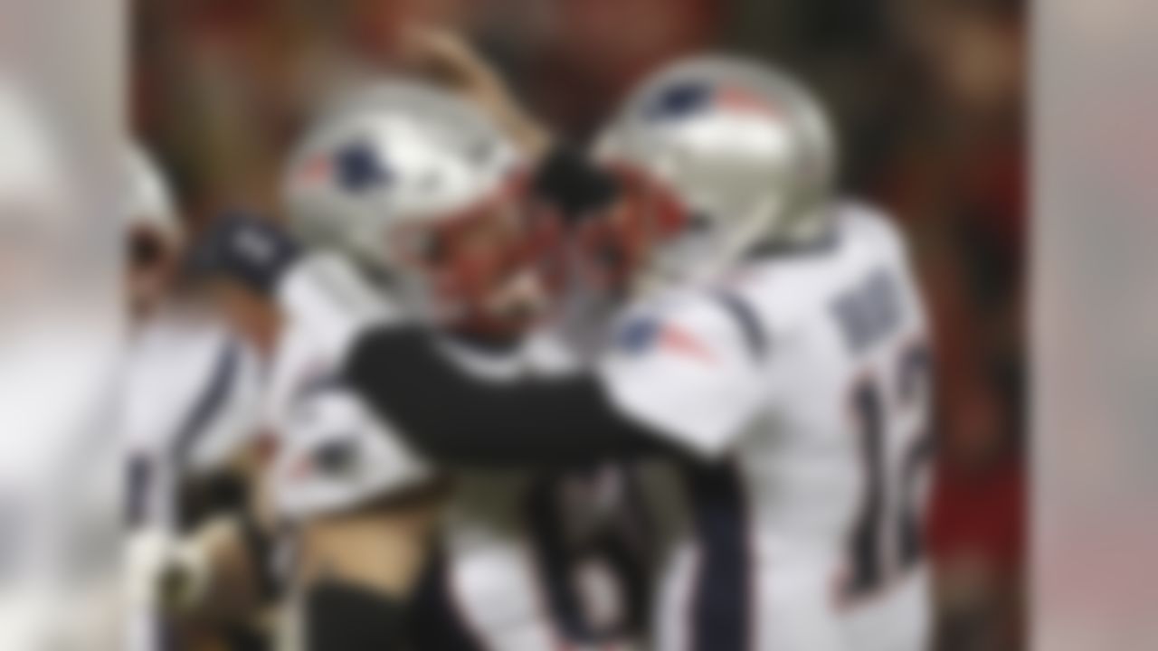 New England Patriots quarterback Tom Brady celebrates with center David Andrews (60) after throwing a touchdown pass to wide receiver Phillip Dorsett during the first half of the AFC Championship NFL football game against the Kansas City Chiefs, Sunday, Jan. 20, 2019, in Kansas City, Mo. (AP Photo/Jeff Roberson)