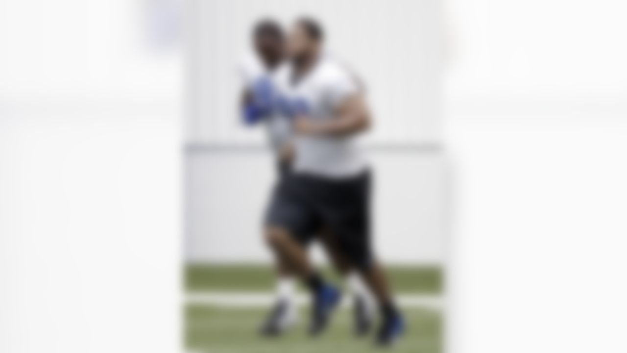 Detroit Lions defensive tackles Nick Fairley, left, and Ndamukong Suh run after NFL football training camp at the team's indoor practice facility in Allen Park, Mich., Friday, July 29, 2011. (AP Photo/Paul Sancya)