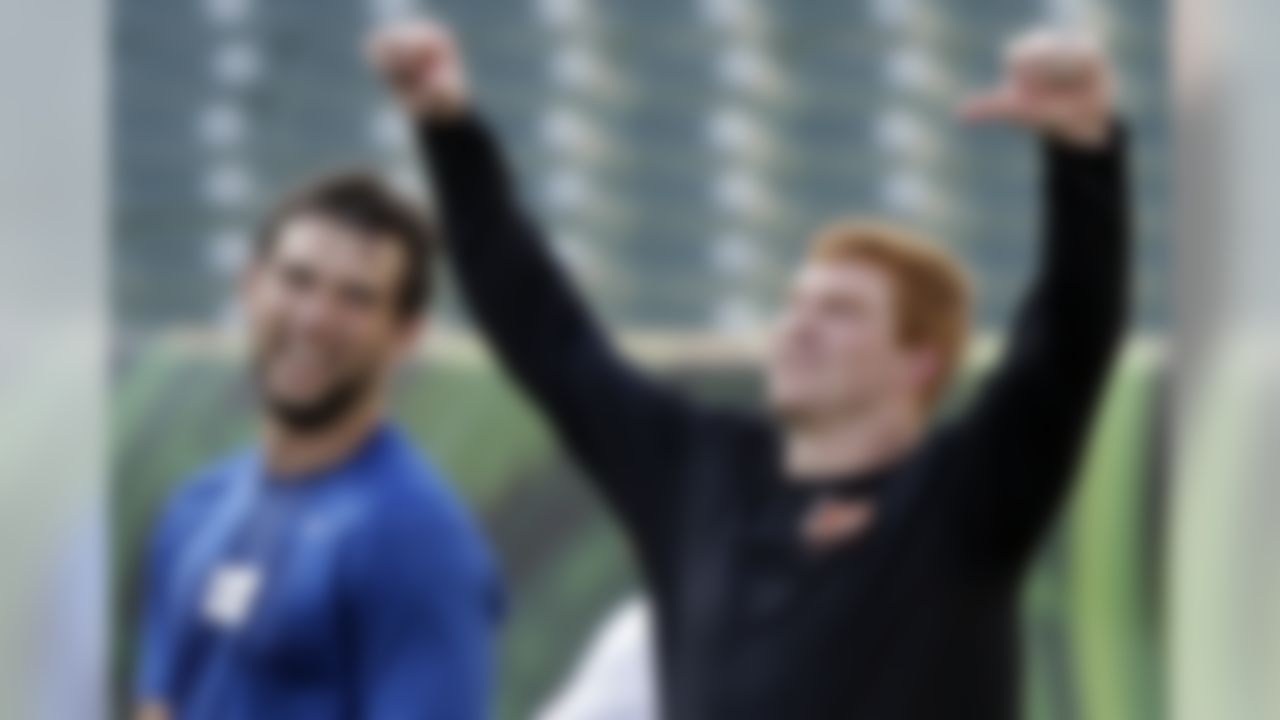 Indianapolis Colts quarterback Andrew Luck, left, and Cincinnati Bengals quarterback Andy Dalton joke around during warmups before an NFL preseason football game, Thursday, Aug. 29, 2013, in Cincinnati. (AP Photo/Al Behrman)