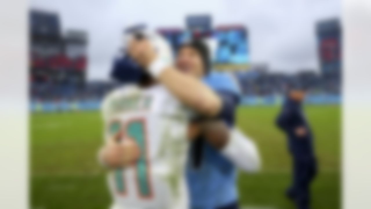 Miami Dolphins wide receiver DeVante Parker (11) and Tennessee Titans quarterback Ryan Tannehill (17) hug after an NFL football game between the Miami Dolphins and the Tennessee Titans on Sunday, January 2, 2022 in Nashville, Tennessee.
