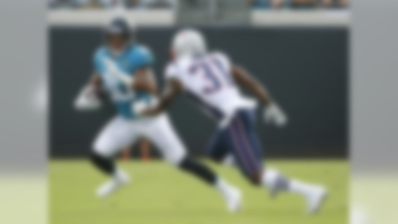 Jacksonville Jaguars running back Corey Grant, left, makes a move to get past New England Patriots defensive back Jonathan Jones (31) during the first half of an NFL football game, Sunday, Sept. 16, 2018, in Jacksonville, Fla. (AP Photo/Stephen B. Morton)