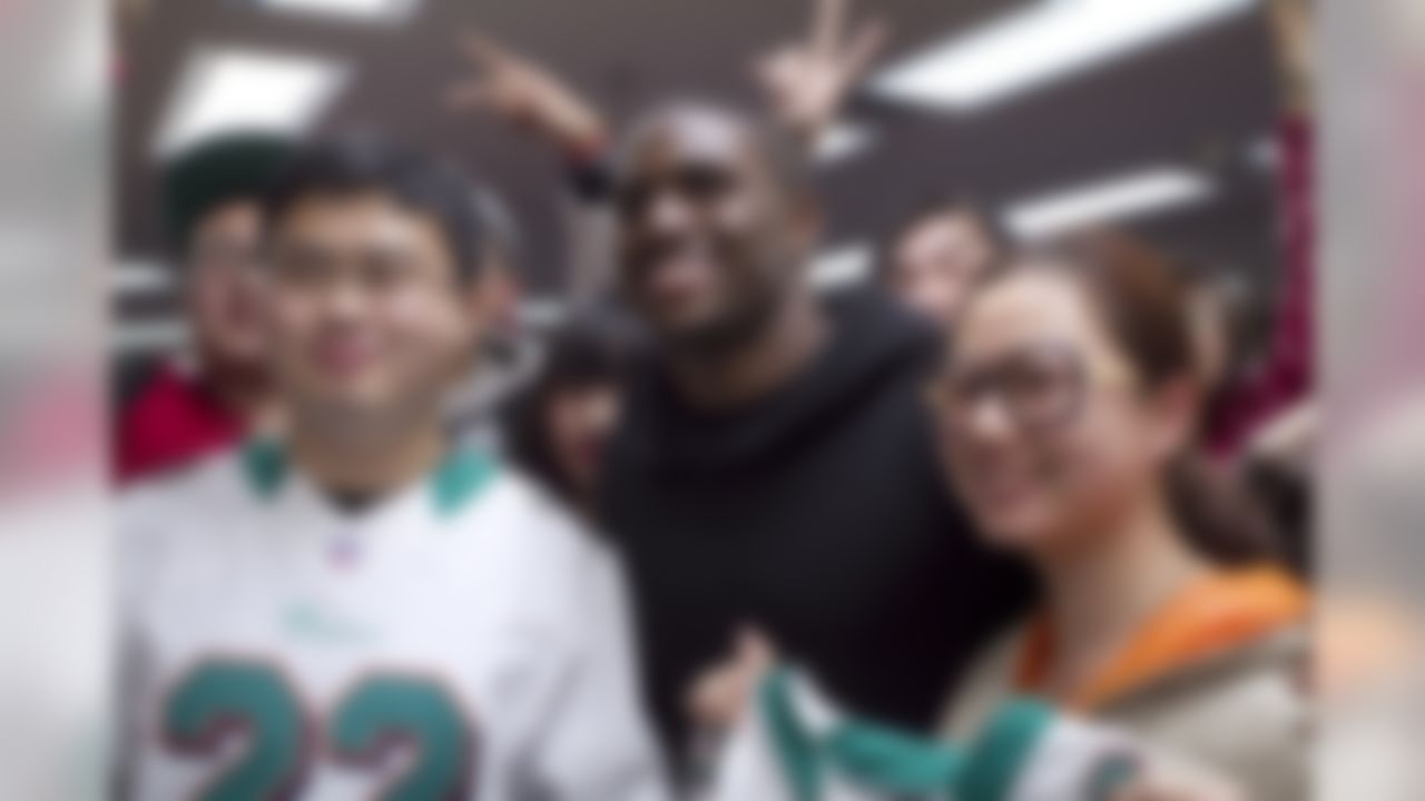 NFL player Reggie Bush poses for a photograph with fans at the Beijing American Center. (Alison Anzalone/Special to NFL.com)