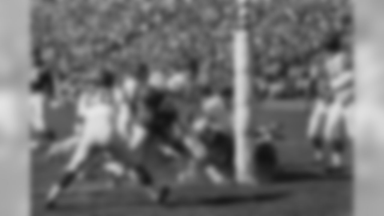 Jim Brown (32, with ball) of the Cleveland Browns and a member of the East All-Stars plunges over from the one-yard line in the first period of Pro Bowl game, Jan. 13, 1963, Los Angeles, Calif. The East score in little more than four minutes of the first period, after Bill Koman of the St. Louis Cardinals recovered a fumble on the West 26-yard line. Others in the picture include: Yale Lary (28), Gino Marchetti (83), Matt Hazeltine (48) and Bill Forester (71) of the West All-Stars; Jim Ray Smith (64) of the East. (AP Photo/Harold Filan)