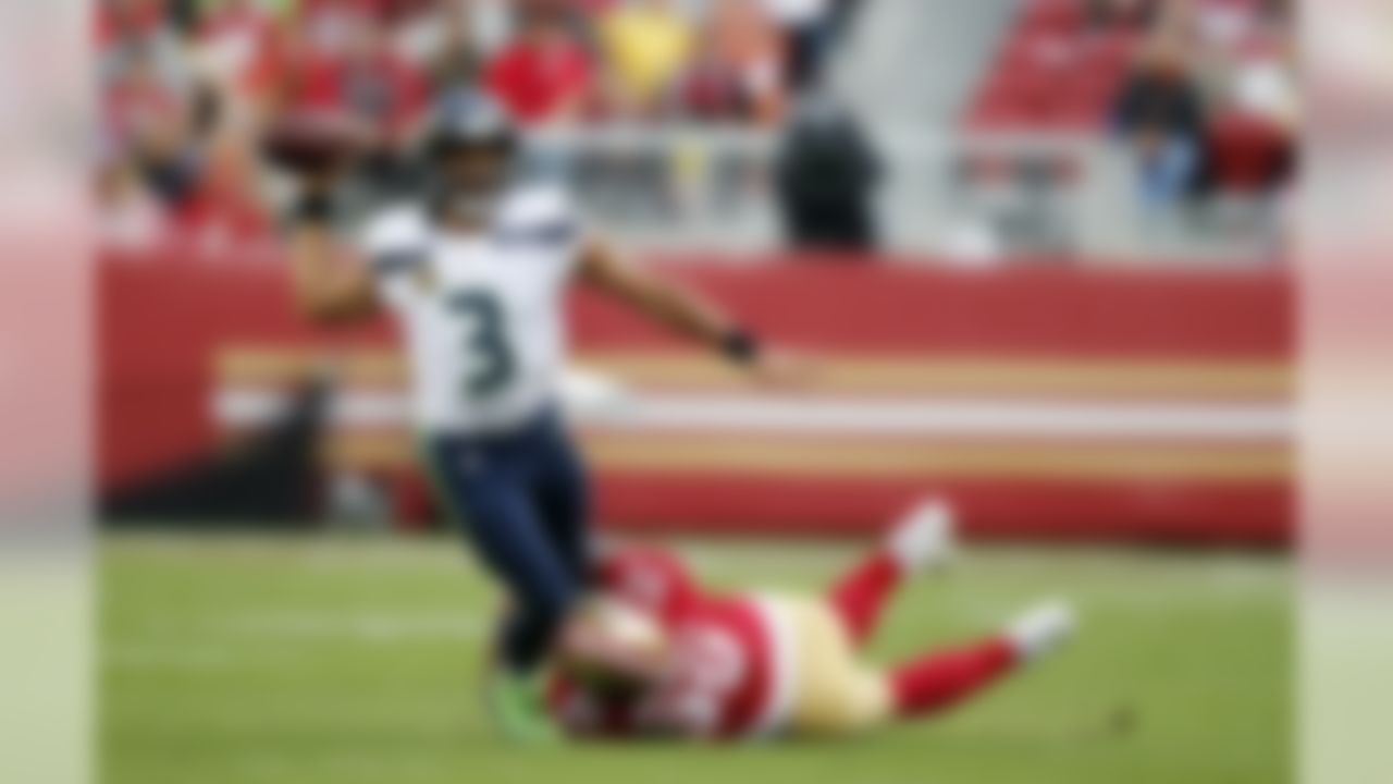 Seattle Seahawks quarterback Russell Wilson (3) throws while being tackled by San Francisco 49ers defensive tackle DeForest Buckner (99) during the first half of an NFL football game Sunday, Nov. 26, 2017, in Santa Clara, Calif. (AP Photo/John Hefti)