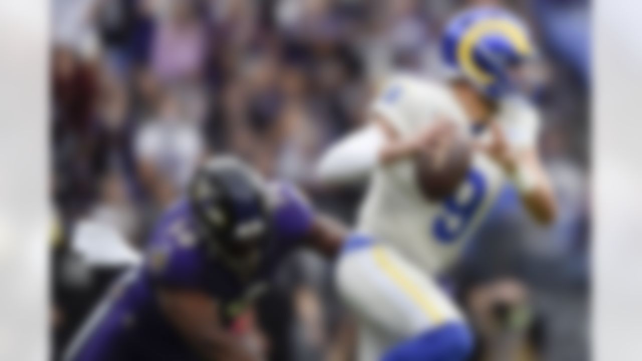 Los Angeles Rams quarterback Matthew Stafford (9) dodges a sack attempt by Baltimore Ravens outside linebacker Justin Houston (50) during the first half of an NFL football game, Sunday, Jan. 2, 2022, in Baltimore.