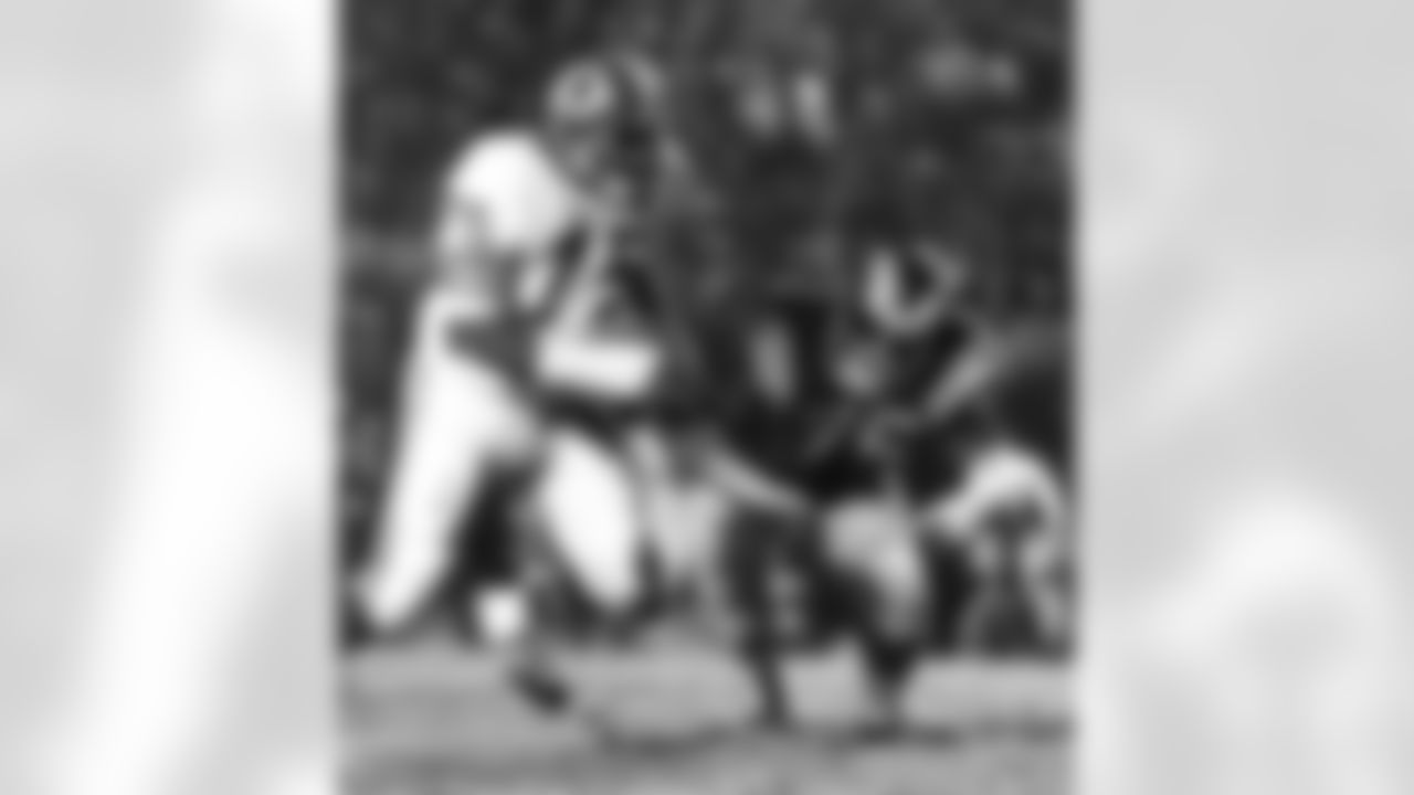 Hall of Fame defensive end David "Deacon" Jones (75) of the Washington Redskins battles the man who replaced him in Rams jersey number 75, tackle John Williams (75) during the Redskins 23-17 victory over the Los Angeles Rams at the Los Angeles Memorial Coliseum. (National Football League)