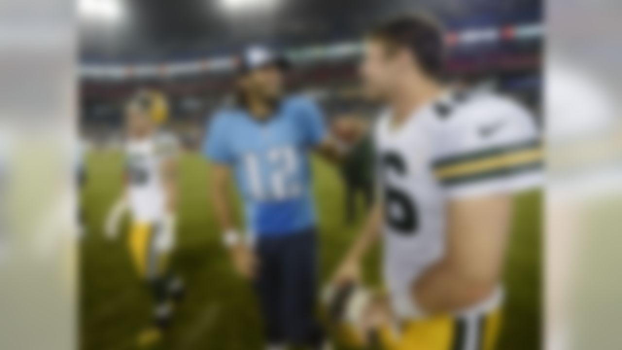 Tennessee Titans quarterback Charlie Whitehurst (12) talks with Green Bay Packers quarterback Scott Tolzien (16) after the Titans defeated the Packers 20-16 in a preseason NFL football game Saturday, Aug. 9, 2014, in Nashville, Tenn. (AP Photo/Mark Zaleski)
