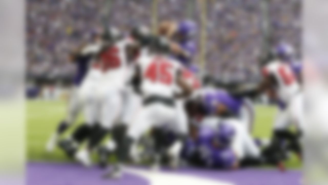 Minnesota Vikings quarterback Kirk Cousins (8) scores on a 1-yard touchdown run during the first half of an NFL football game against the Atlanta Falcons, Sunday, Sept. 8, 2019, in Minneapolis. (AP Photo/Bruce Kluckhohn)