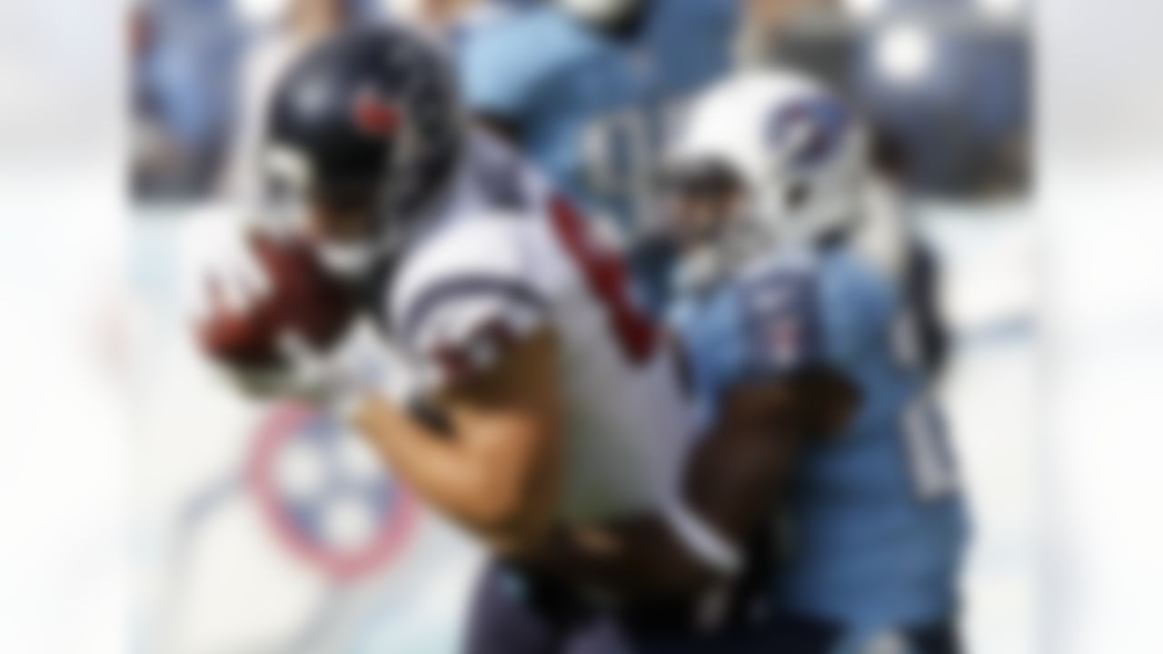 Houston Texans wide receiver Kevin Walter (83) is pulled down by Tennessee Titans defensive back Alterraun Verner (20) in the first quarter of an NFL football game on Sunday, Dec. 2, 2012, in Nashville, Tenn. (AP Photo/Wade Payne)