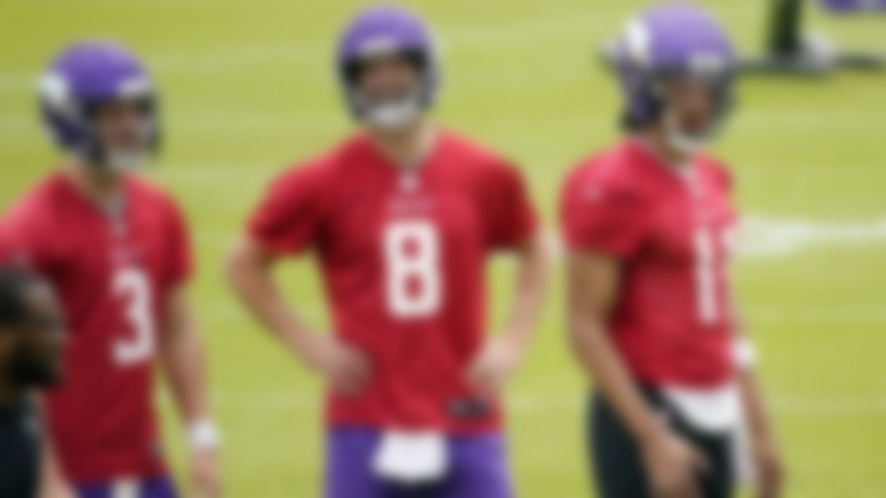 Minnesota Vikings quarterbacks Jake Browning (3) and Kirk Cousins (8) enjoy a laugh during a break with rookie quarterback Kellen Mond (11) during NFL football practice in Eagan, Minn., Wednesday, June 2, 2021.