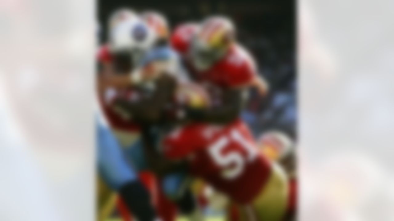 Tennessee Titans running back Chris Johnson (28) is wrapped up by San Francisco 49ers linebackers Patrick Willis (52) and Takeo Spikes (51) an NFL game on November 8, 2009. The Titans defeated the 49ers 34-27. (AP Photo/Kevin Terrell)