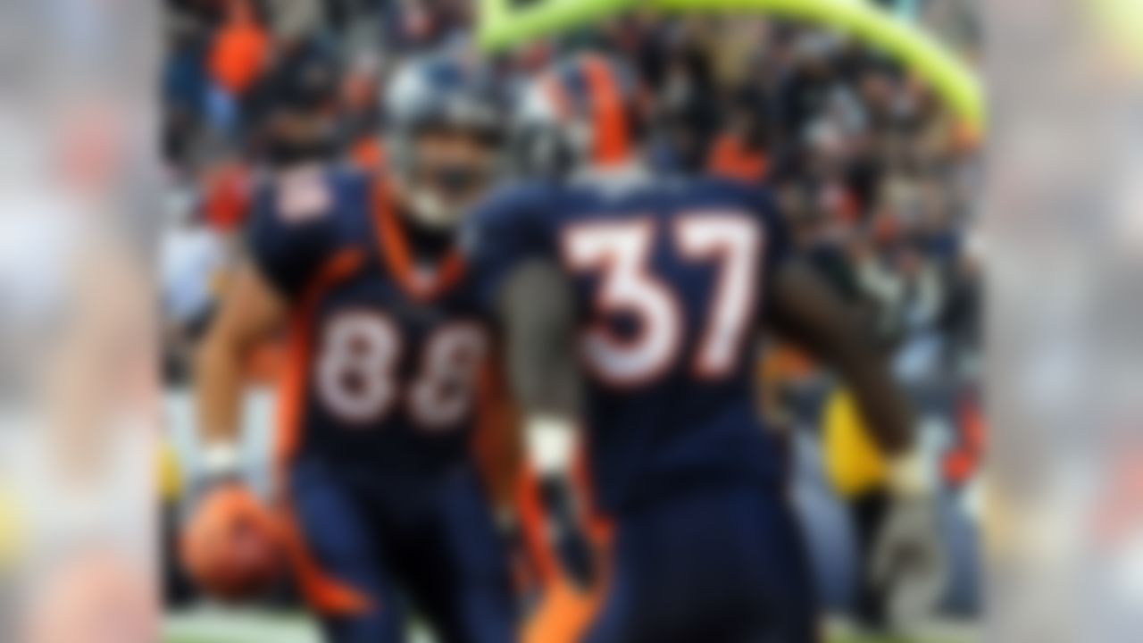 DENVER - DECEMBER 30:  Tony Scheffler #88 and Cecil Sapp #37 of the Denver Broncos celebrate Scheffler's touchdown catch in the second quarter of the football game at Invesco Field at Mile High December 30, 2007 in Denver, Colorado.  (Photo by Steve Dykes/Getty Images)