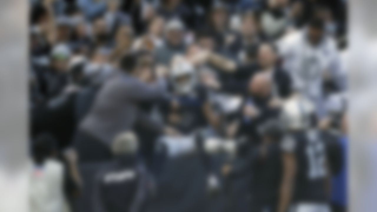 Oakland Raiders wide receiver Tyrell Williams is mobbed by fans after scoring a touchdown during the first half of an NFL football game against the Jacksonville Jaguars in Oakland, Calif., Sunday, Dec. 15, 2019. (AP Photo/Ben Margot)