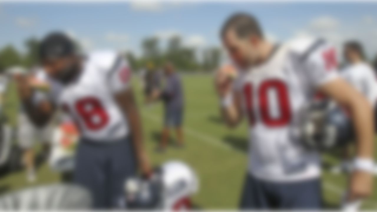 Houston Texans wide receiver London Crawford (18) and quarterback John David Booty (10) enjoy a slice of watermelon at NFL football training camp in Metairie, La., Thursday, Aug. 19, 2010. The New Orleans Saints and the Texans are holding joint practice session leading up to their preseason game on Saturday night.  (AP Photo/Bill Haber)