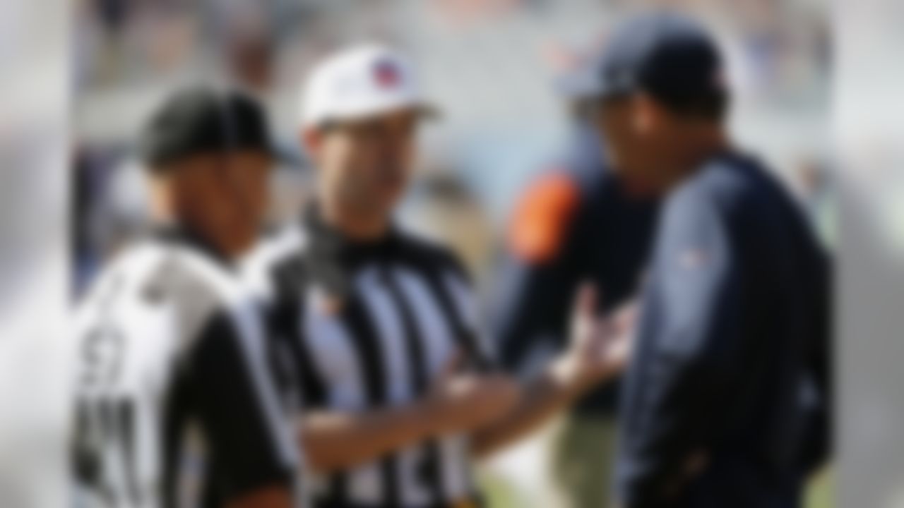 Chicago Bears head coach Marc Trestman, right, talks to officials Tom Hill, left, and Brad Allen before an NFL football game against the Buffalo Bills on Sunday, Sept. 7, 2014, in Chicago. (AP Photo/Charles Rex Arbogast)