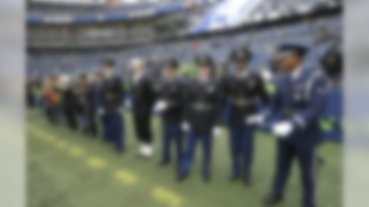 Military service members stand on the field near the end zone before an NFL football game between the Seattle Seahawks and the Washington Redskins, Sunday, Nov. 5, 2017, in Seattle. Sunday was the Seahawks' annual NFL football Salute to Service game.