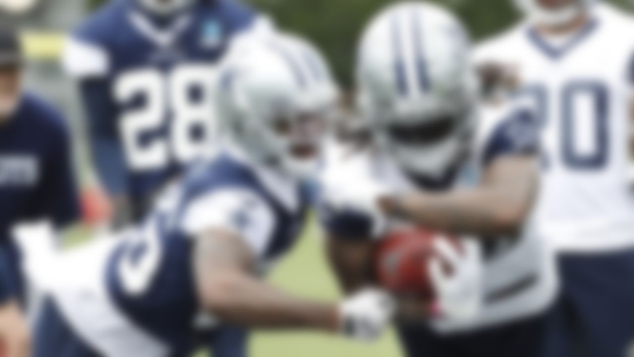Dallas Cowboys cornerback Jourdan Lewis (left) tries to punch the ball away from receiver CeeDee Lamb (right) during an NFL football organized team activity at the team's training facility Tuesday, June 1, 2021 in Frisco, Texas.