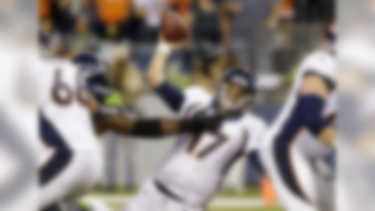 Denver Broncos quarterback Brock Osweiler (17) is knocked down by Seattle Seahawks' Brandon Mebane while passing in the first half of a preseason NFL football game, Saturday, Aug. 17, 2013, in Seattle. (AP Photo/Elaine Thompson)