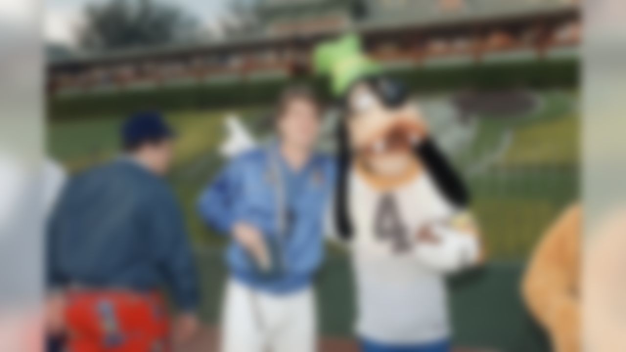 Heisman Trophy finalist Jim Harbaugh is held by Goofy, who sports the quarterback�s jersey number, as the Michigan Wolverines tackled Disneyland on Saturday, Dec. 27, 1986 in Anaheim during a break in their practice schedule for the upcoming Rose Bowl. The Wolverines meet Arizona State University in the Pasadena classic New Year�s Day. (AP Photo/Bob Galbraith)
