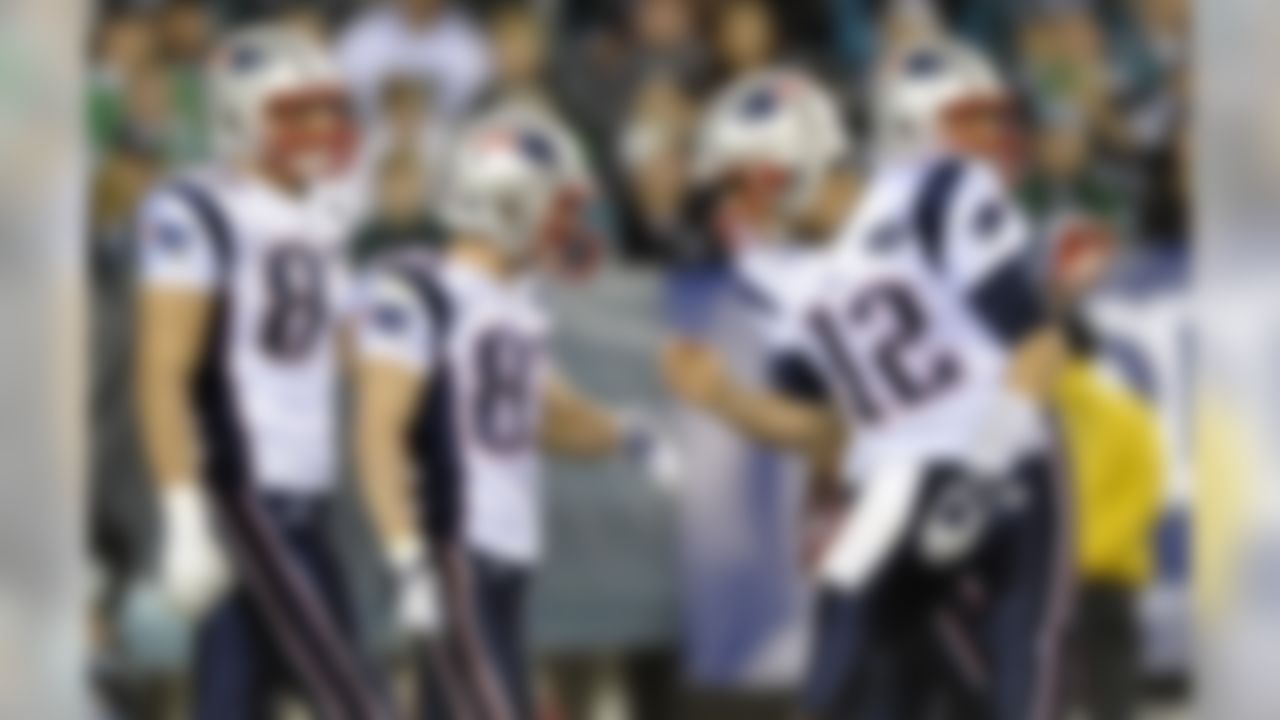 New England Patriots quarterback Tom Brady, right, reacts with wide receiver Wes Welker, second from left, and tight end Rob Gronkowski (87), left, after Welker's touchdown during the first half of an NFL football game against the Philadelphia Eagles, Sunday, Nov. 27, 2011, in Philadelphia. (AP Photo/Michael Perez)