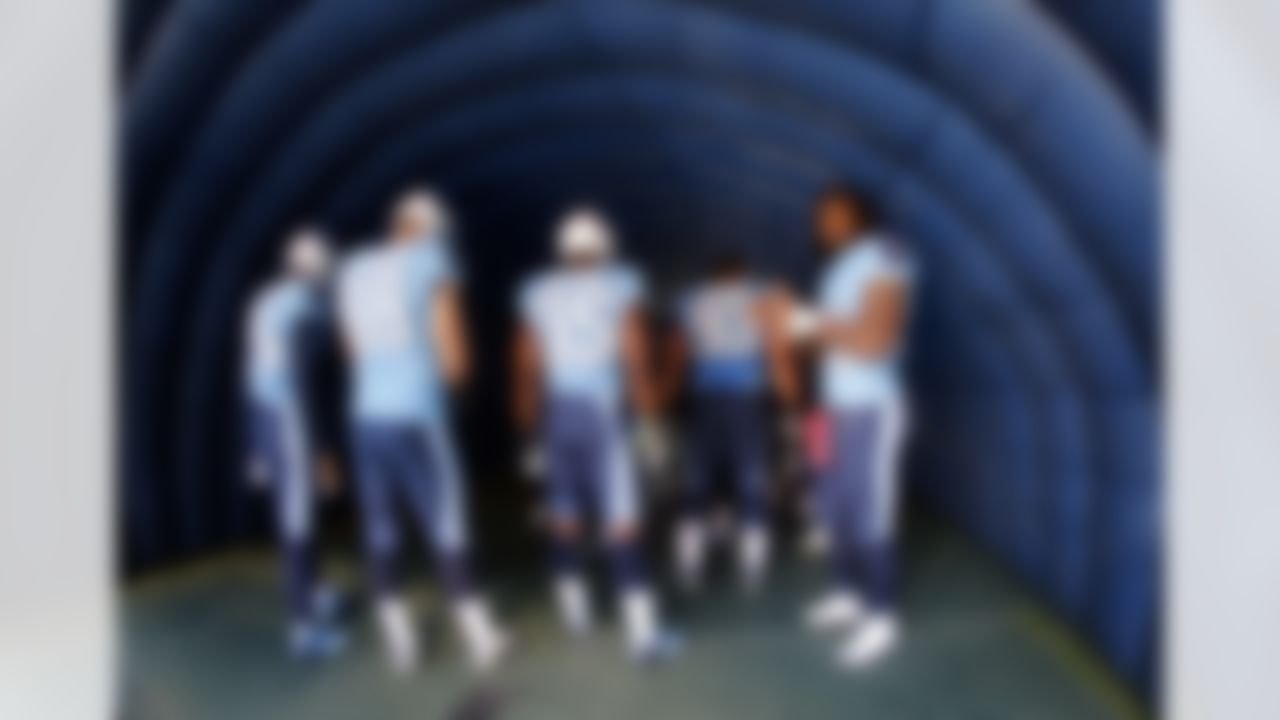 Tennessee Titans players Chris Johnson, right, Craig Stevens (88), Tracy Wilson (35), and Mike Martin (93) wait to be introduced before an NFL football game against the Houston Texans on Sunday, Dec. 2, 2012, in Nashville, Tenn. (AP Photo/Joe Howell)