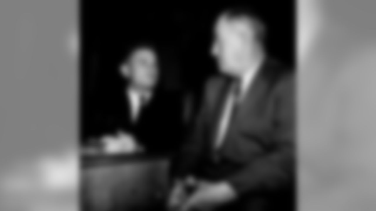 Yale Lary, right, Detroit Lions' star back, and newly-elected member of the Texas House of Representatives from Fort Worth, chats with a former football star, J. Gordon Bristow, House member from Big Spring, in Austin, Tex., Jan. 14, 1959. Lary, a former Texas A&M player, played in the Pro-Bowl game last Sunday and reported to his legislative post in time for the opening session. (AP Photo/Dave Taylor)