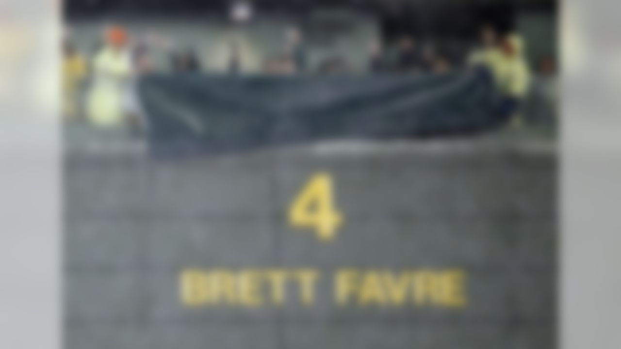 Brett Favre's retired No. 4 and name were unveiled inside Lambeau Field during the ceremony at halftime of an NFL football game between the Green Bay Packers and Chicago Bears Thursday, Nov. 26, 2015, in Green Bay, Wis. (AP Photo/Morry Gash)