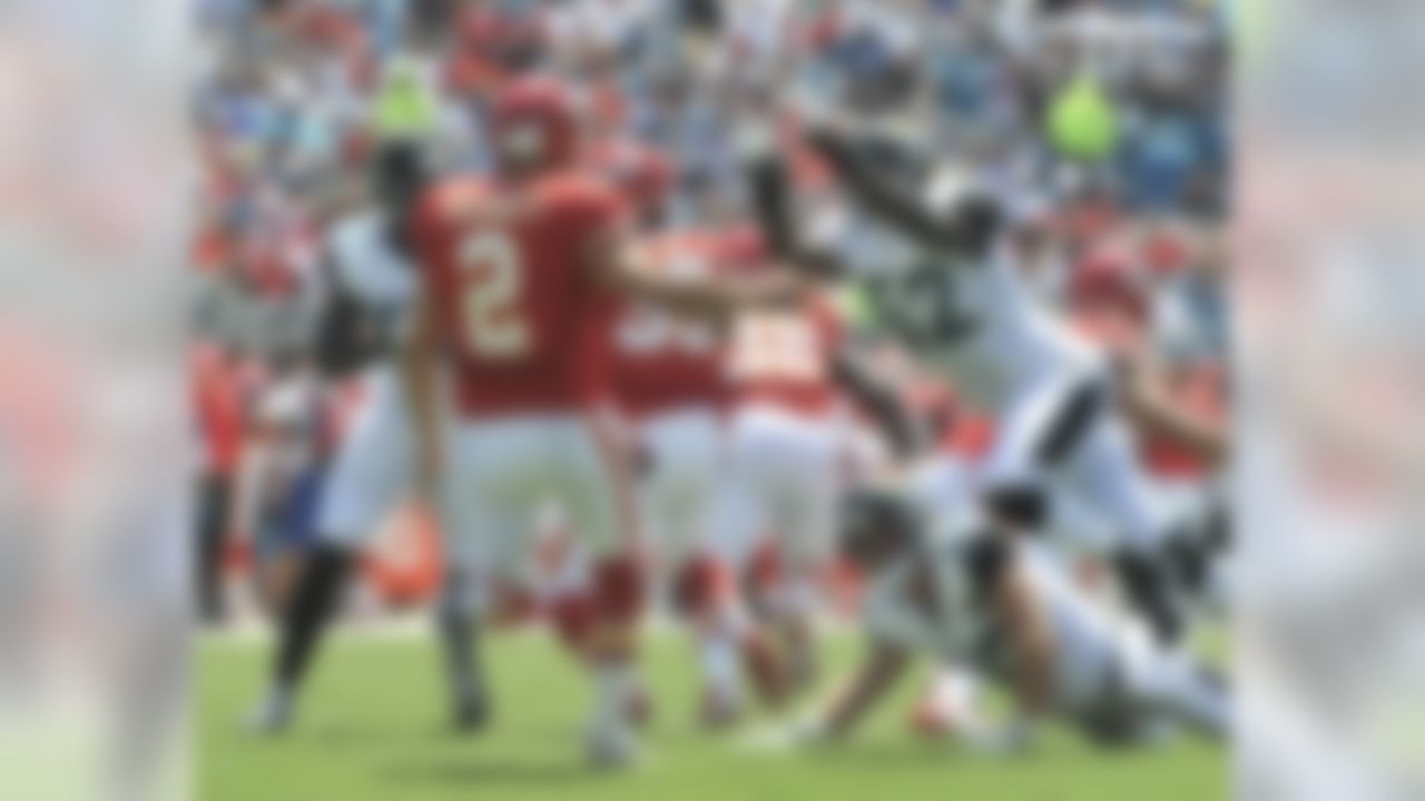 Jacksonville Jaguars linebacker J.T. Thomas (52) goes up to block a punt by Kansas City Chiefs' Dustin Colquitt (2) during the first half of an NFL football game in Jacksonville, Fla., Sunday, Sept. 8, 2013. The block resulted in a safety and two points for the Jaguars.(AP Photo/Stephen Morton)