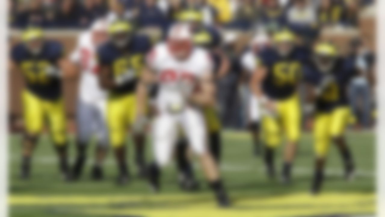 Wisconsin lineman J.J. Watt is chased by the Michigan offensive line after intercepting a deflected pass deflected during the fourth quarter of a NCAA college football game in Ann Arbor, Mich., Saturday, Nov. 20, 2010. (AP Photo/Carlos Osorio)