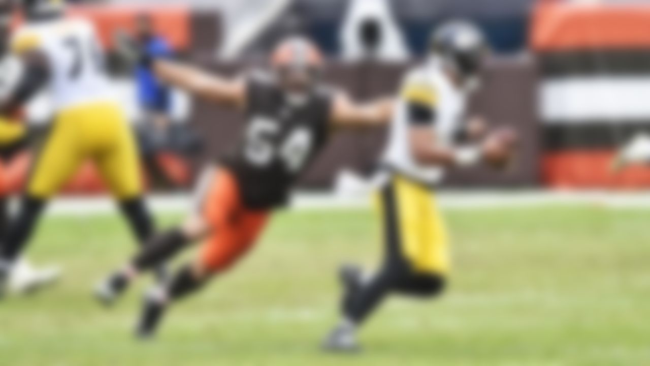 Cleveland Browns defensive end Olivier Vernon (54) tries to tackle Pittsburgh Steelers quarterback Joshua Dobbs (5) during the second half of an NFL football game, Sunday, Jan. 3, 2021, in Cleveland.