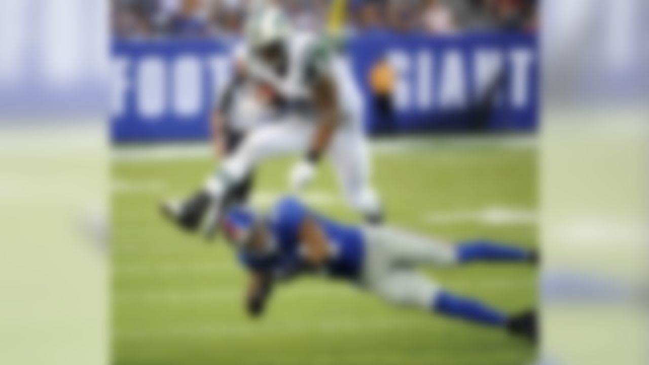 New York Jets tight end Kellen Winslow (81) jumps over New York Giants cornerback Terrell Thomas (24) during the first half of a preseason NFL football game, Saturday, Aug. 24, 2013, in East Rutherford, N.J. (AP Photo/Bill Kostroun)