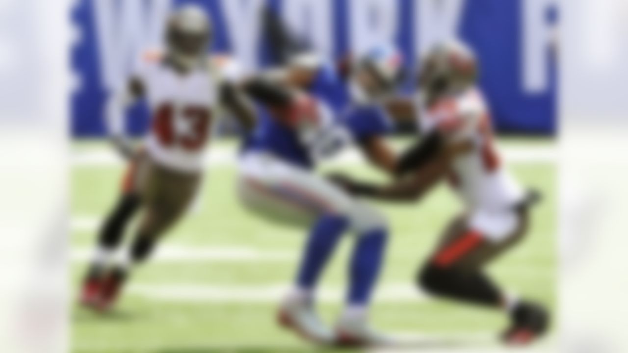 Tampa Bay Buccaneers cornerback Aqib Talib, right, and Ahmad Black, left, pressure New York Giants wide receiver Hakeem Nicks (88) after he made a catch during the first half of an NFL football game, Sunday, Sept. 16, 2012, in East Rutherford, N.J. (AP Photo/Bill Kostroun)